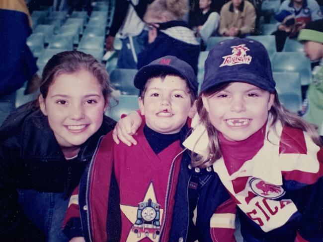 Australian Jillaroo star centre Jess Sergis back in the day, cheering on the Roosters with her sister Vivienne and brother Brandon. (Supplied)