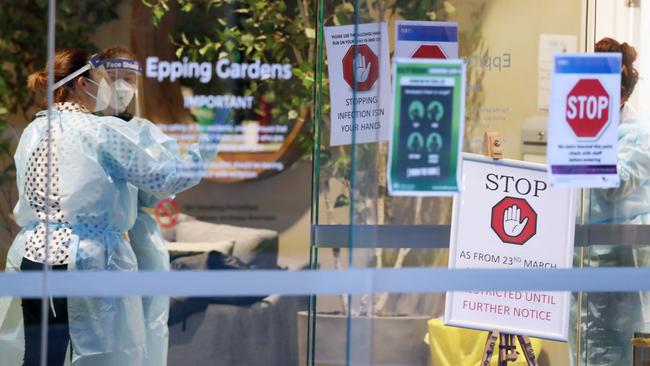 Healthcare workers begin moving sick residents from Epping Gardens nursing home. Picture: David Crosling