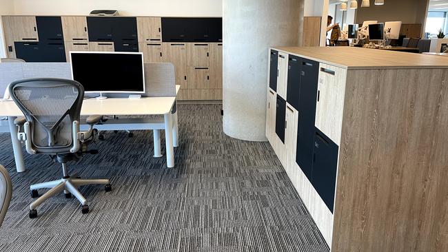 Open area with desks. Lockers act as dividers of the open office space.