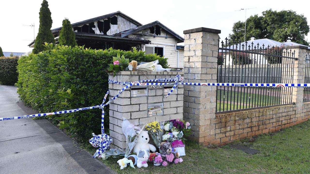Flowers and soft toys left by community members following a triple fatal house fire in Harristown. Picture: Kevin Farmer