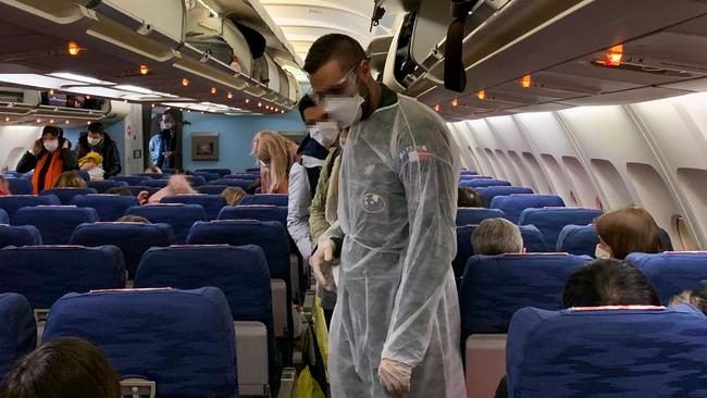 French citizens arrive and settle aboard an evacuation plane in Wuhan, to fly to southeastern France where they will be quarantined for 14-days. Picture: Hector Retamal/AFP