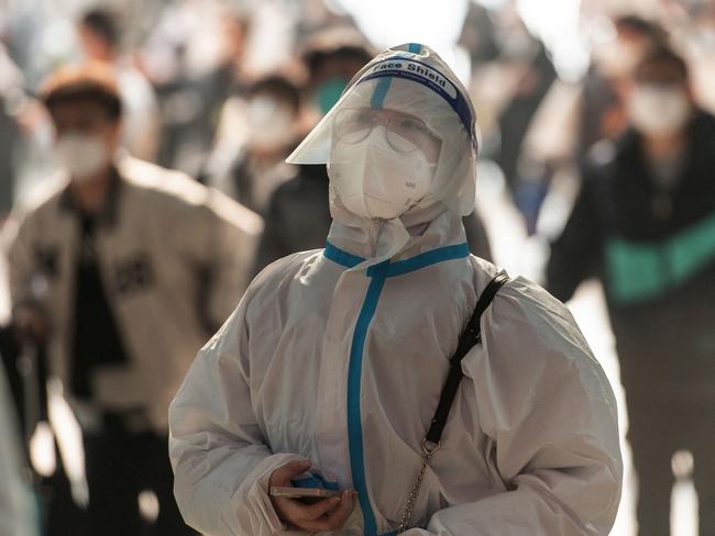 A passenger wearing personal protective equipment amid the Covid-19 pandemic arriving at Hankou Railway Station in Wuhan in China. Picture: AFP