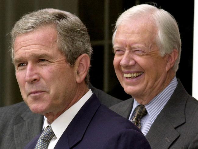 George W. Bush with Jimmy Carter in the White House Rose Garden in 2001. Picture: AFP