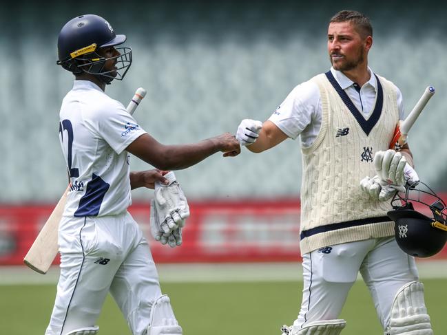 Merlo (R) and Ashley Chandrasinghe walk off together for lunch. (Photo by Mark Brake/Getty Images)