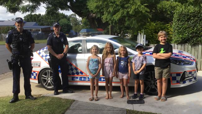 Boondall Police officers Senior Constable Ben Foley and Senior Constable Nathan Jones visited children in Lyndhurst Rd, Boondall a day after a man was found hiding under one of their houses. They are with (from left) Eadie Maddock, Daisy and Poppy Williams, Harry Littlejohn and Finn Maddock.