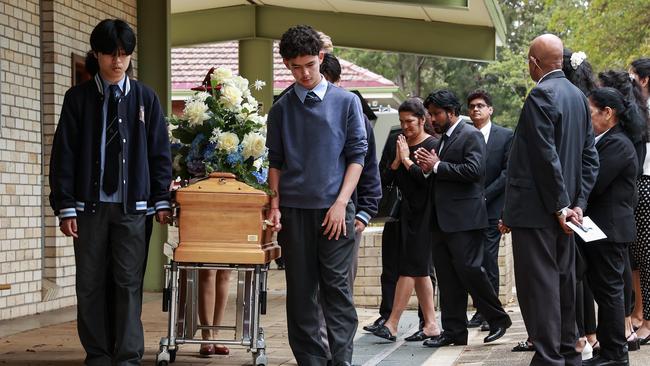 Calvin Wijeweera’s coffin is taken into St Gerard Majella’s Catholic Church as his mum Anoma and dad Sandun follow it. Picture: Justin Lloyd