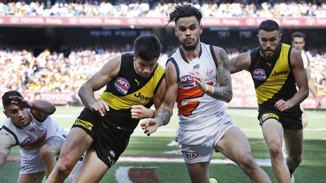 Trent Cotchin of the Tigers and Zac Williams of the Giants contest the ball in the AFL decider.