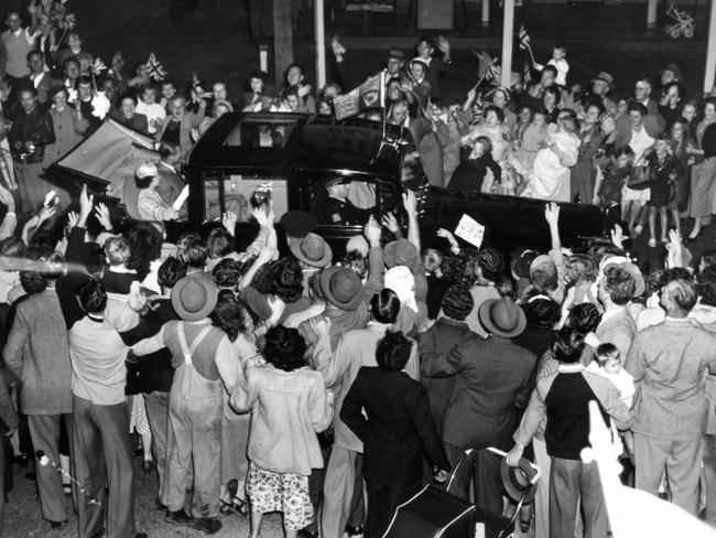 Crowds rush the car containing the Queen on the road at Gepps Cross as royal car made its way from Parafield Airport to city after she and Prince Philiparrived in South Australia on March 18.