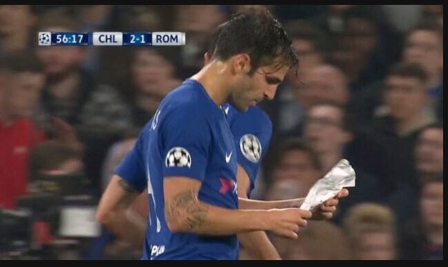 Cesc Fabregas reads instructions supplied by Antonio Conte.