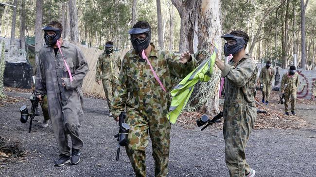 Travis Boak congratulates paintball teammate Karl Amon for securing the “flag” with Ollie Wines coming in behind them. Picture: Sarah Reed