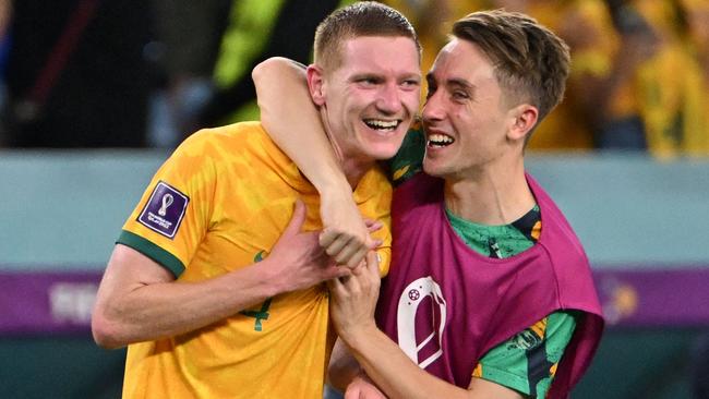 Australia's defenders Kye Rowles (L) and Joel King celebrate winning the Qatar 2022 World Cup Group D football match between Australia and Denmark.