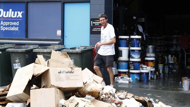 A man cleaning up outside a business in Milton. Picture: Tertius Pickard