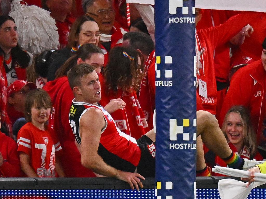 Dougal Howard of the Saints jumps back onto the field after falling into the Swans’ cheer squad. Picture: Morgan Hancock/AFL Photos/via Getty Images.