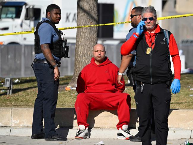 A person is detained by police near the shooting. Picture: Andrew Caballero-Reynolds/AFP