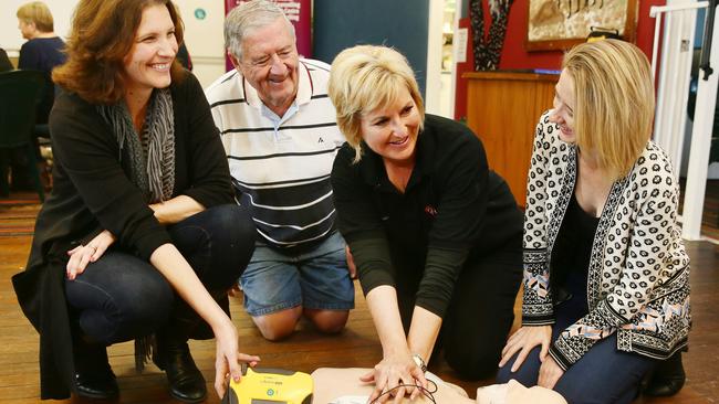 Julie Hughes, Tony Collins, Karen Galpin and Kelly Drover, learn how to use the new defibrillator, at Mingaletta, Umina Beach. Picture:Peter Clark