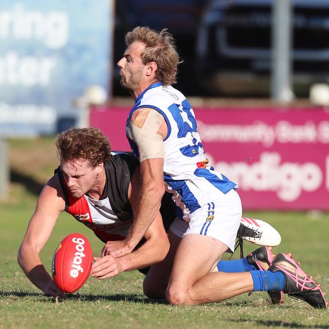 Myrtleford’s Kye Agosta is taken to ground by Corowa-Rutherglen’s Jamie Wells.