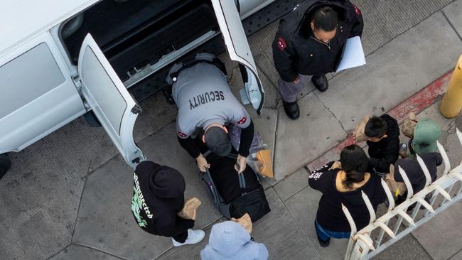 Deportees unload from a Customs and Border Protection transport vehicle while being sent back into Mexico. Picture: AFP