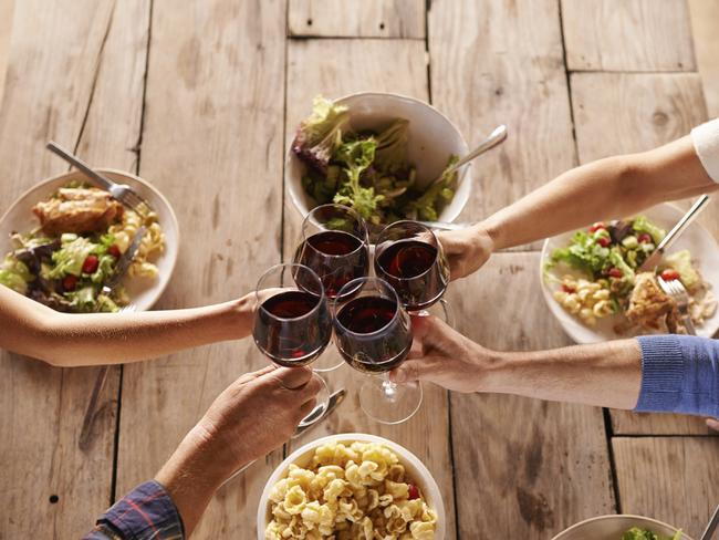 Shot of people toasting with wine over a meal. Picture: iStock