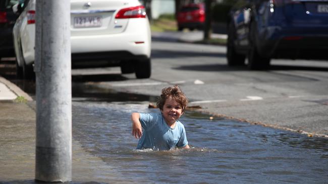 Flooding from the King tide at Budds Beach at Surfers Paradise was made worse by the approaching storm system. Locals Alberto Scuteri 4 enjoys the water, not so his parents. Picture Glenn Hampson