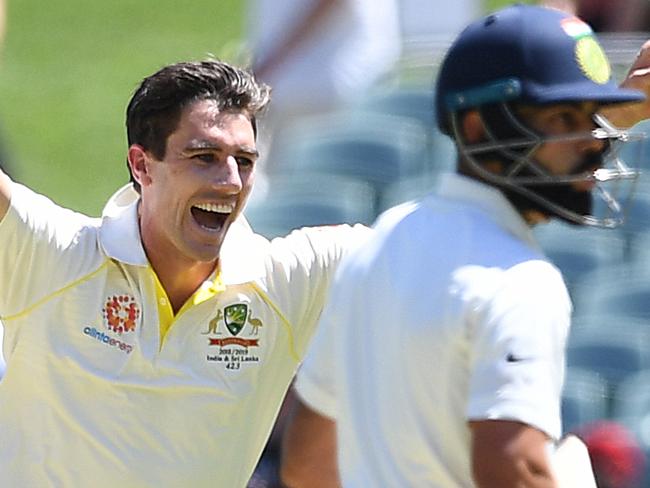 Australian bowler Pat Cummins reacts after dismissing Indian batsman Virat Kohli (right) for 3 runs during day one of the first Test match between Australia and India at the Adelaide Oval in Adelaide, Thursday, December 6, 2018. (AAP Image/Dave Hunt) NO ARCHIVING, EDITORIAL USE ONLY, IMAGES TO BE USED FOR NEWS REPORTING PURPOSES ONLY, NO COMMERCIAL USE WHATSOEVER, NO USE IN BOOKS WITHOUT PRIOR WRITTEN CONSENT FROM AAP