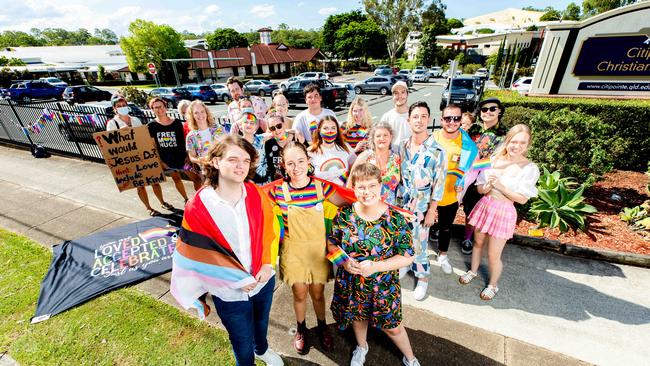 Emmey Leo, Felicity Myers and Bethany Lau gather to protest outside Citipointe Christian College on Monday. Picture: Richard Walker