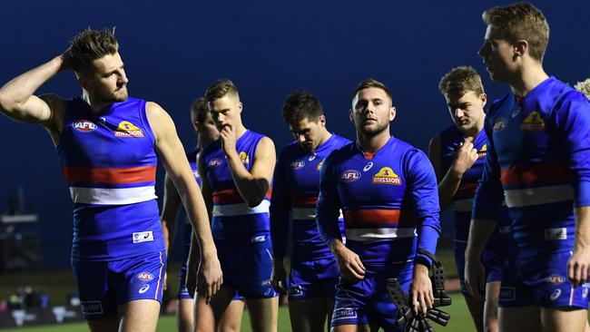 Marcus Bontempelli leads the Bulldogs off after losing to Port Adelaide.