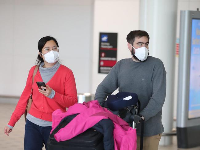 People arrive from Shanghai into Brisbane International Airport. Pic Peter Wallis