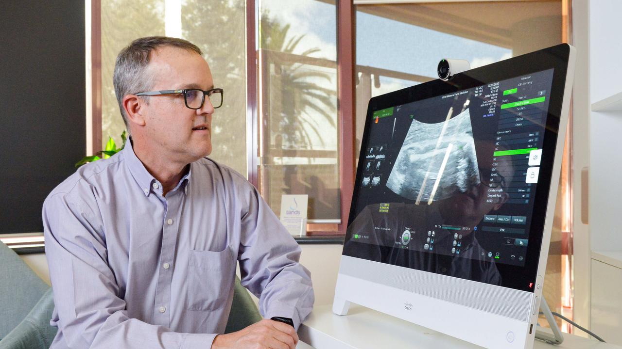 Dr Peter Muller watches a live ultrasound of a woman 34 weeks pregnant using telehealth technology in May. Picture: Brenton Edwards