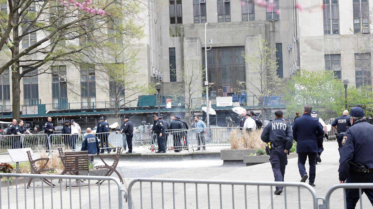 Paramedics attend to a person who lit themselves on fire near Manhattan Criminal Court on April 19, 2024 in New York City. (Photo by Michael M. Santiago / GETTY IMAGES NORTH AMERICA / Getty Images via AFP)