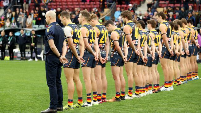 Crows players stand for a minute’s silence in memory of Kerley before their clash with the Demons at Adelaide Oval. Picture: AFL Photos/Getty Images