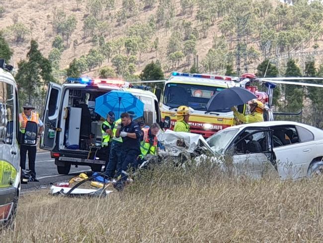 Emergency workers are battling midday heat as  they try to help three seriously injured people