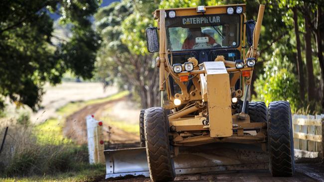 Tasman Highway will be closed from Friday for around a month making it difficult to access the towns of Triabunna and Orford, a grader on Wielangta Road. Picture: Chris Kidd