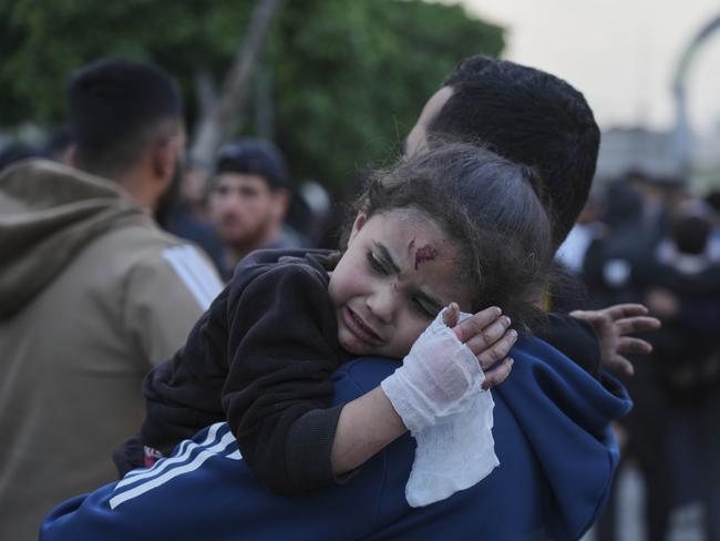 A Palestinian girl who was injured in an Israeli air strike is brought for a treatment at the Baptist Hospital in Gaza City. Picture: AP