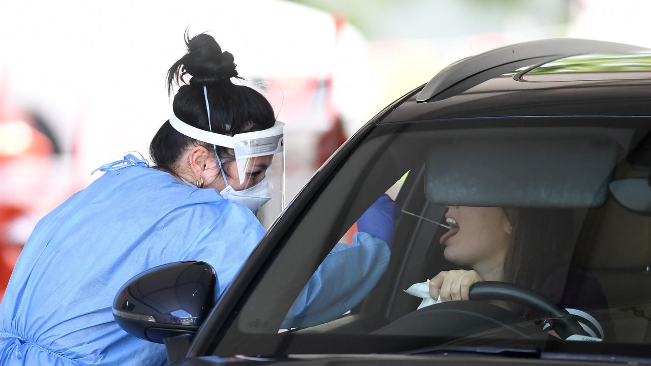 A health worker swabs a woman at a Covid-19 testing clinic in Brisbane. Picture: NCA NewsWire / Dan Peled