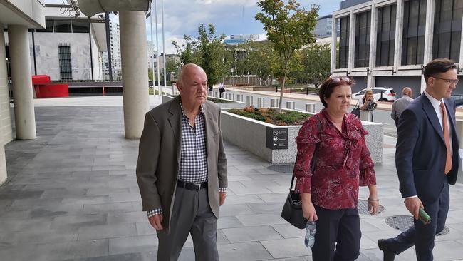 John Walter Cattle, left, a former Canberra tennis coach, leaves the ACT Supreme Court on the first day of his historic child sex offence trial. He is accompanied by a supporter and his solicitor. Picture: Craig Dunlop