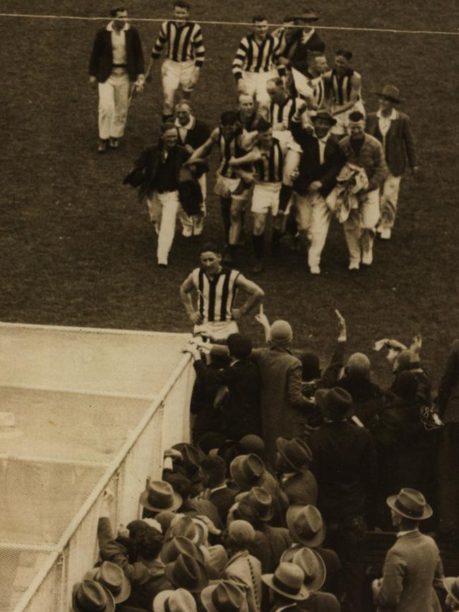 Syd Coventry sits on the shoulders of trainers and players as the group nears the MCG race after the 1930 Grand Final. Picture: The Machine