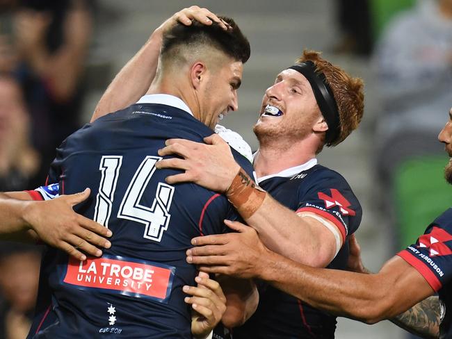 Jack Maddocks (left) of the Rebels reacts after scoring a try during the Round 4 Super Rugby match between the Melbourne Rebels and the Brumbies at AAMI Park in Melbourne, Friday, March 8, 2019. (AAP Image/Julian Smith) NO ARCHIVING, EDITORIAL USE ONLY