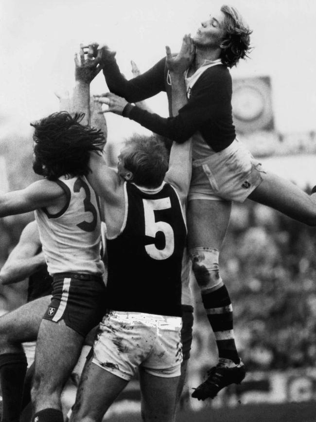 Trevor Barker flies over the top of Rex Hunt and Francis Jackson in a match between South Melbourne and St Kilda in 1978.