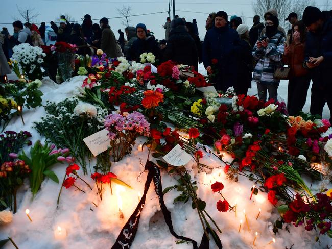 People pay tribute to late Russian opposition leader Alexei Navalny at a makeshift memorial outside the Borisovo cemetery following his funeral ceremony in Moscow. Picture: AFP