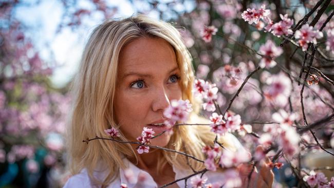 A woman admires the idyllic blooms. Picture: Christian Gilles