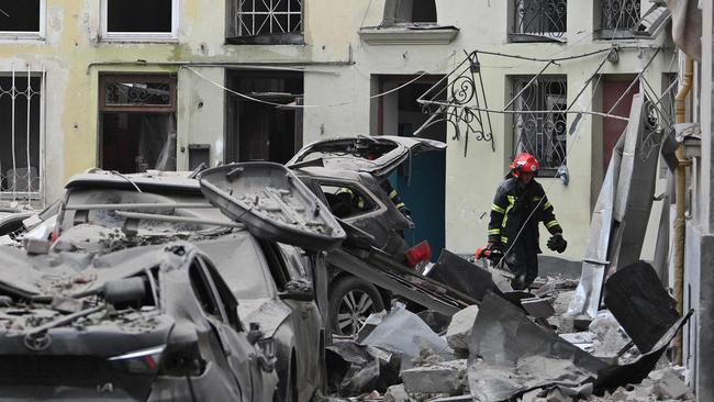 A rescuer works in an apartment building partially destroyed by a missile strike in the western Ukrainian city of Lviv on July 6, 2023. Picture: Yuriy Dyachyshyn / AFP.