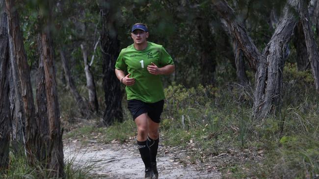 Melbourne forward Max King running through bushland. Photo: Darcy Parkinson