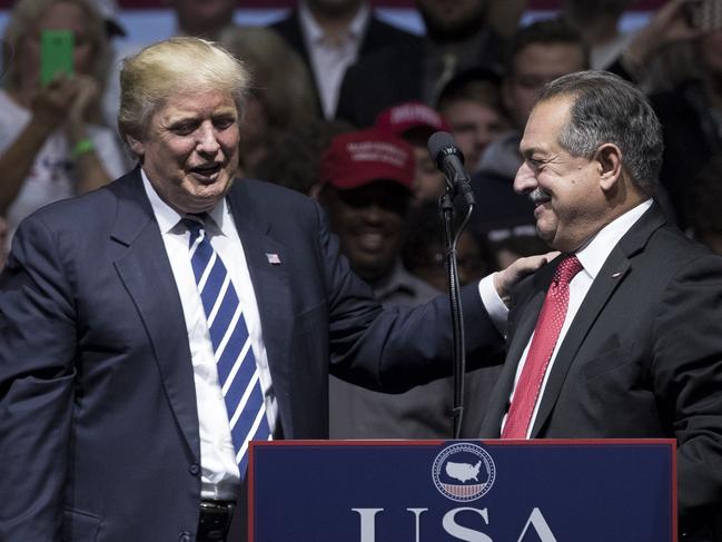 GRAND RAPIDS, MI - DECEMBER 9: (L to R) President-elect Donald Trump introduces Andrew N. Liveris, chief executive officer of The Dow Chemical Company and Trump's choice to be the head of a national manufacturing council, at the DeltaPlex Arena, December 9, 2016 in Grand Rapids, Michigan. President-elect Donald Trump is continuing his victory tour across the country.   Drew Angerer/Getty Images/AFP == FOR NEWSPAPERS, INTERNET, TELCOS & TELEVISION USE ONLY ==