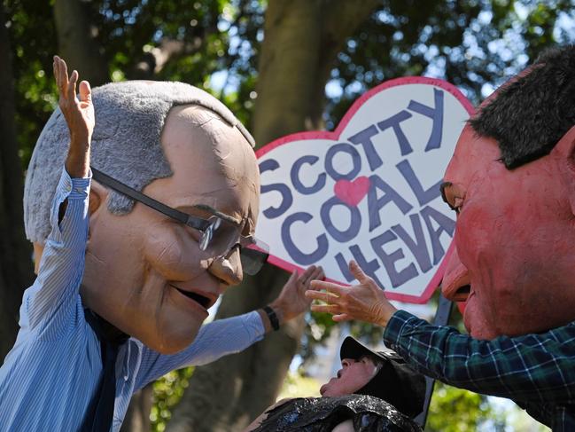 People wear caricatures of Australian Prime Minister Scott Morrison (L) and Deputy Prime Minister Barnaby Joyce (R) during a rally as part of a global day of action on climate change in Sydney. Photo: Steven Saphore