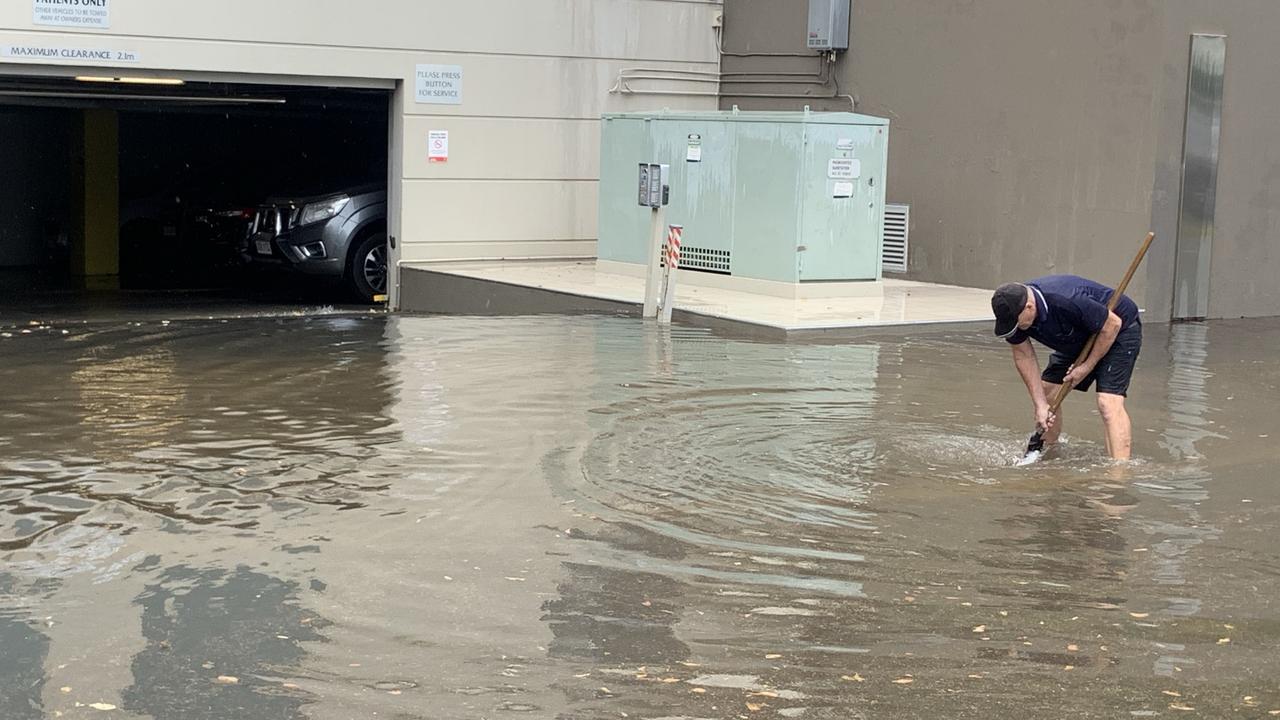 Rain floods the entryway to a car park in Southport. Picture: Emily Halloran