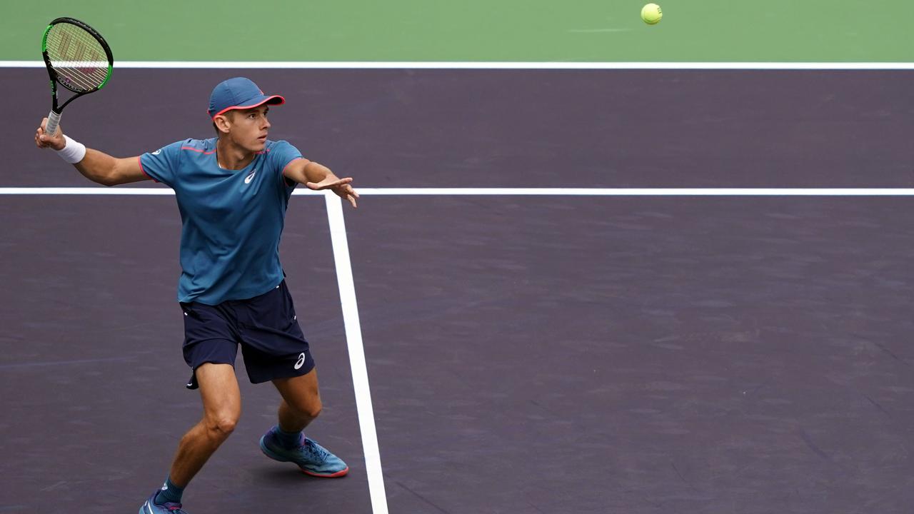 Alex de Minaur pepares to hit a return to Alexander Zverev.