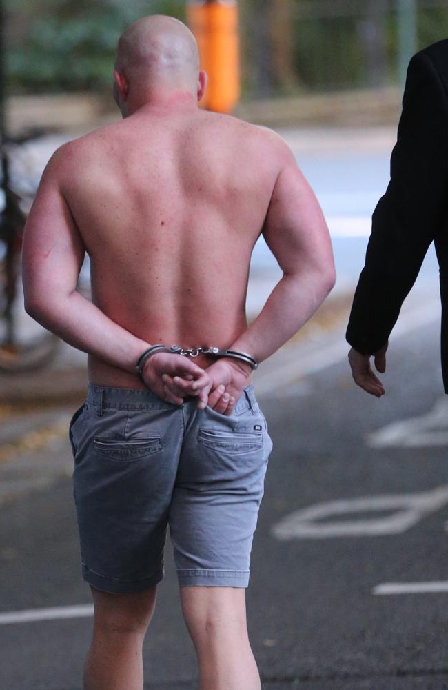 A man is led away by police. Picture: John Grainger