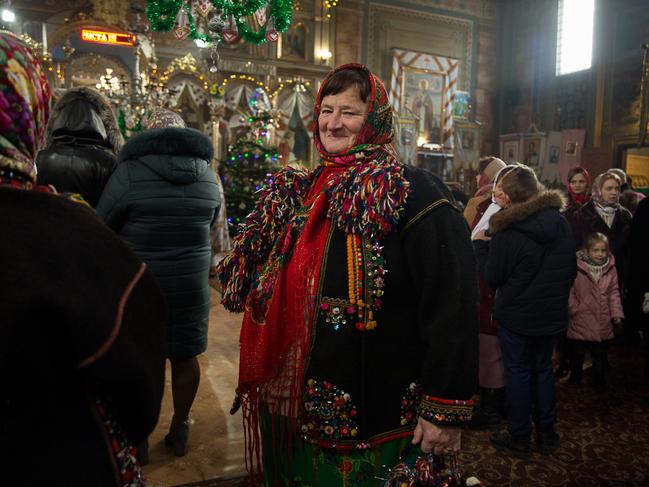 A woman wears traditional Hutsul clothes during a Christmas mass at Holy Trinity Church in Iltsi, Ukraine. Picture: Getty