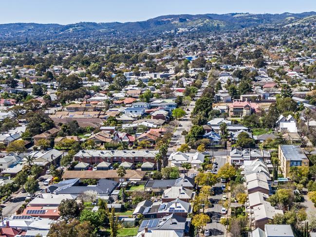 Aerial view of sprawling leafy eastern suburbs of Adelaide with Mt Lofty Ranges in the background