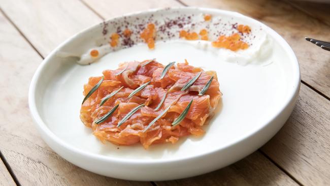 Chunks of cured trout are decorated with tarragon leaves and accessorised by an arc of lemon yoghurt topped with little outcrops of trout roe. 